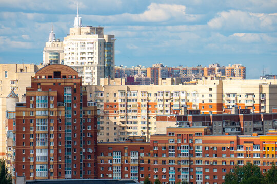 Modern city skyline panorama with residential apartment buildings under blue sky.
