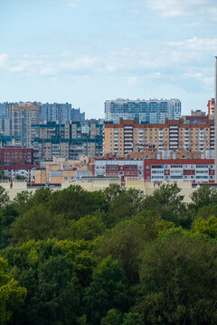 Modern city skyline panorama with residential apartment buildings under blue sky.
