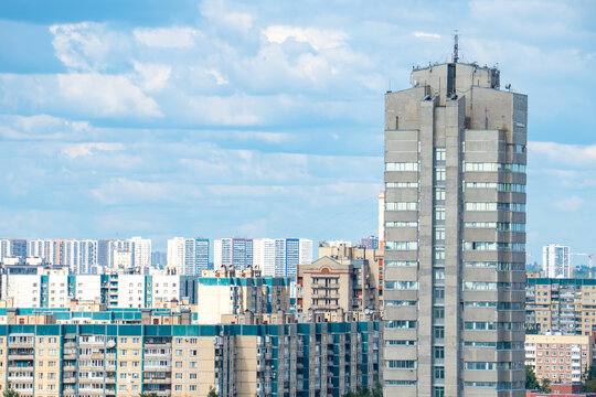 Modern city skyline panorama with residential apartment buildings under blue sky.

