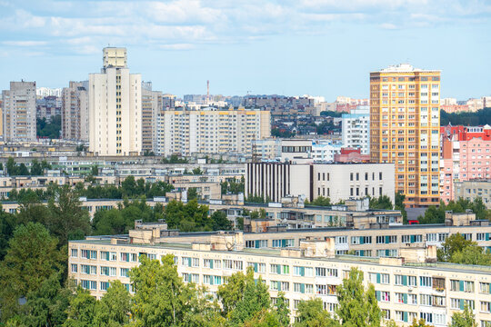Modern city skyline panorama with residential apartment buildings under blue sky.

