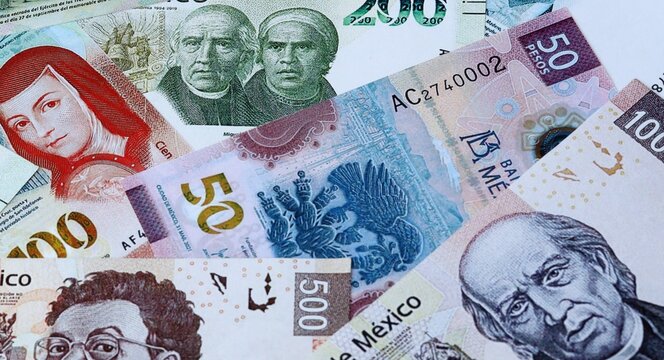 Mexican peso money bills in pile on table. Mexico MXN currency cash close up