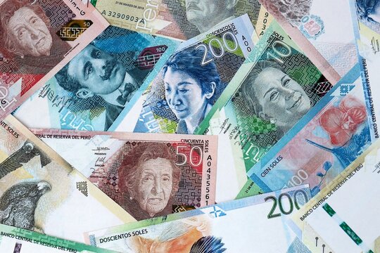 Peruvian sol money bills in pile on table. Peru PEN currency cash close up