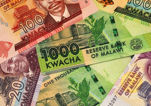 Malawian kwacha money bills in pile on table. Malawi MWK currency cash close up