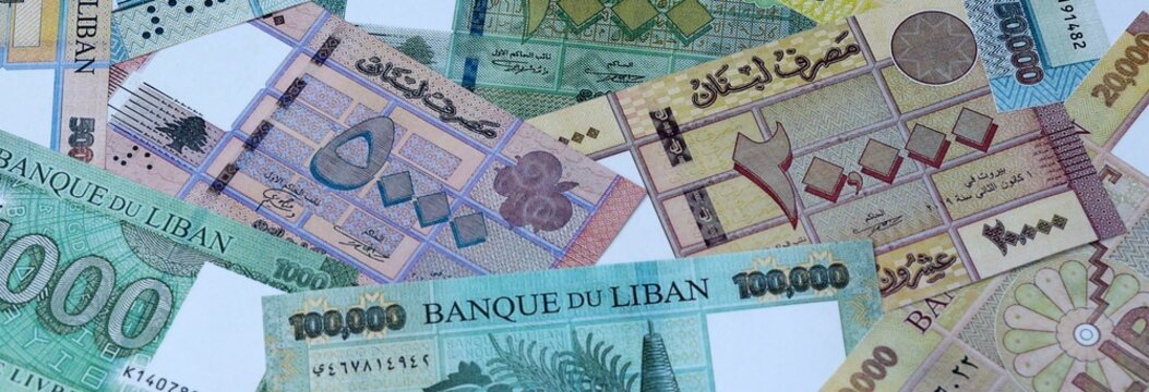 Lebanese pound money bills in pile on table. Lebanon LBP currency cash close up