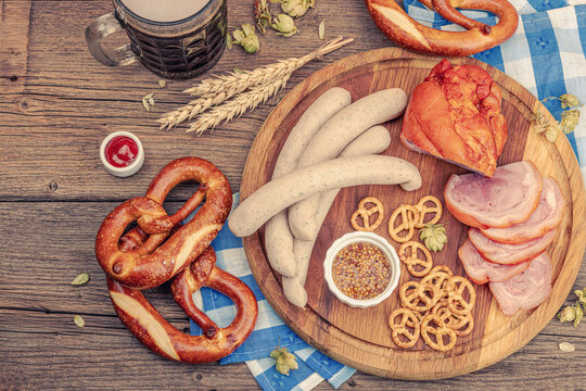 Traditional Oktoberfest set. Pretzels, beer, weisswurst, eisbein with mustard. German festival food