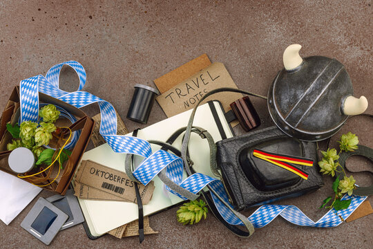 Vintage travel memories scattered across the table. Oktoberfest tickets, film slides, Viking helmet