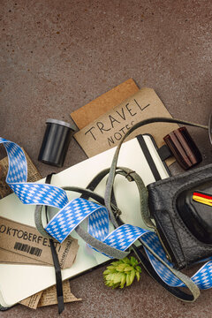 Vintage travel memories scattered across the table. Oktoberfest tickets, film slides, Viking helmet