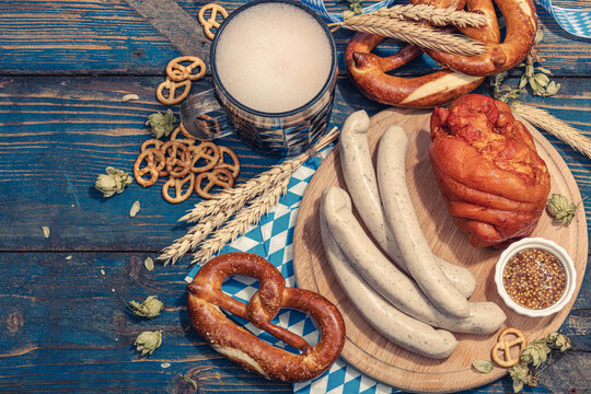 Traditional Oktoberfest set. Pretzels, beer, weisswurst, eisbein with mustard. German festival food