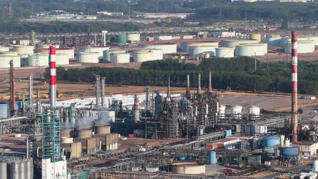 Aerial view of industrial pipes and equipment at an oil refinery plant. Heavy manufacturing infrastructure for petroleum production.