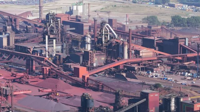 Aerial drone view of a heavy metallurgical plant producing steel. Industrial facility with manufacturing buildings and infrastructure.