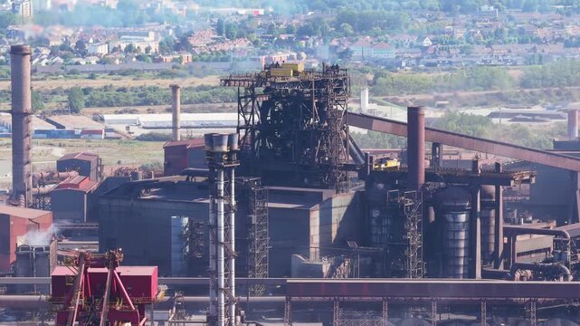 Aerial drone view of a heavy metallurgical plant producing steel. Industrial facility with manufacturing buildings and infrastructure.