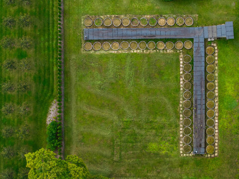 Aerial view of the T-shaped structure with circular garden beds and surrounding green lawn at the Traku Voke manor estate in Vilnius, Vilnius County, Lithuania.