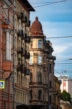 Classic historic building stone facade with art nouveau ornaments and windows pattern close up.
