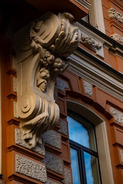 Classic historic building facade decorative stone bracket sculpture close up.
