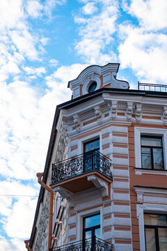 Classic historic building stone facade with art nouveau ornaments and windows pattern close up.
