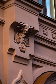 Classic historic building facade decorative stone bracket sculpture close up.

