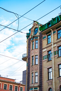 Classic historic building stone facade with art nouveau ornaments and windows pattern close up.

