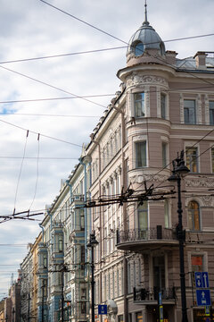 Classic historic building stone facade with art nouveau ornaments and windows pattern close up.
