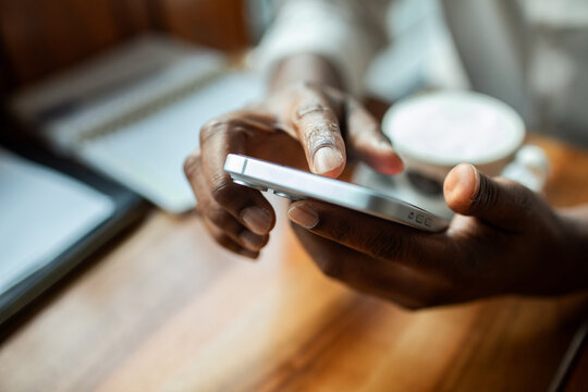 Person using smartphone at coffee shop table