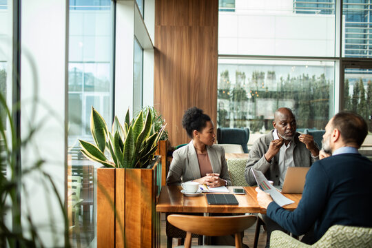 Colleagues discussing strategy in a modern cafe