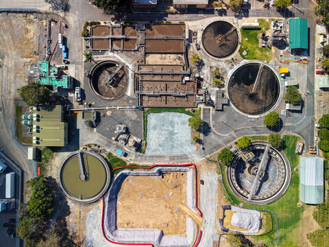 Aerial view of Unitywater Brendale Sewerage Treatment Plant with circular clarifiers, aeration tanks, and construction site in Brendale, Queensland, Australia.