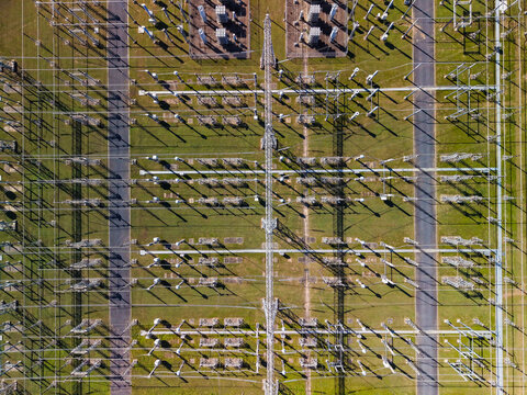 Aerial view of power transmission lines and transformers at an electrical substation with complex infrastructure and grid patterns in Brendale, Queensland, Australia.