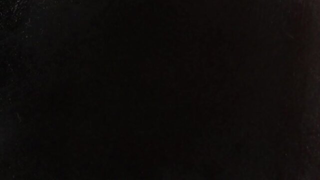 dark textured background with subtle light reflections, abstract surface, grunge overlay, atmospheric mood