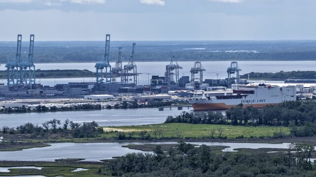 Aerial view of the Port of Jacksonville featuring a large Grimaldi Lines cargo ship docked near container cranes and industrial infrastructure in Jacksonville, Florida, United States.