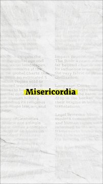 Misericordia text - on yellow banner over vintage minimalist white newspaper background