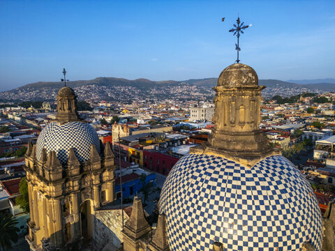Aerial view of the Templo de Santo Domingo de Guzman with its iconic blue and white tiled domes, overlooking the historic city of Oaxaca, Oaxaca, Oaxaca, Mexico.