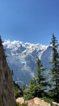 Brevent cable car cabin moving against Glacier des Bossons background Chamonix Mont Blanc valley famous alpine cableway public transport French Alps mountain landscape summer travel vertical 4K video