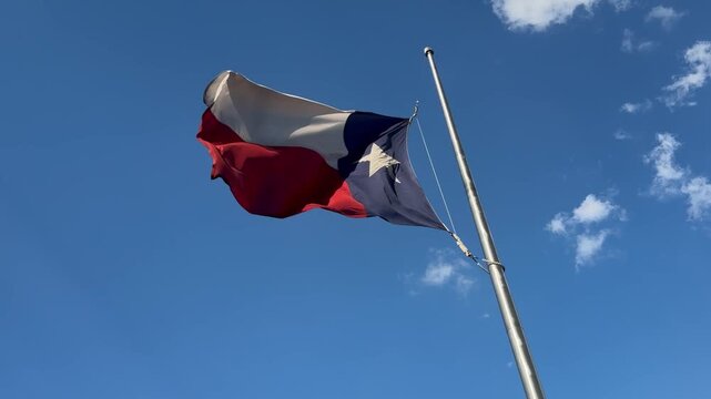 Texas flag flying at half staff