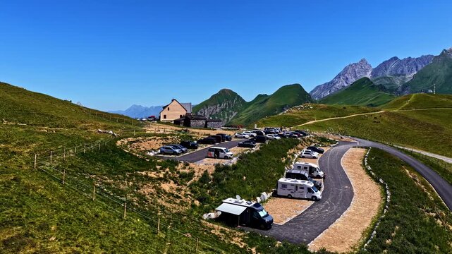 Camper vans parked on Col d'Aubisque mountain road, scenic travel and adventure destination in France.
