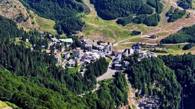 A small mountain township nestled in Col d'Aubisque, surrounded by lush green hills and forests.