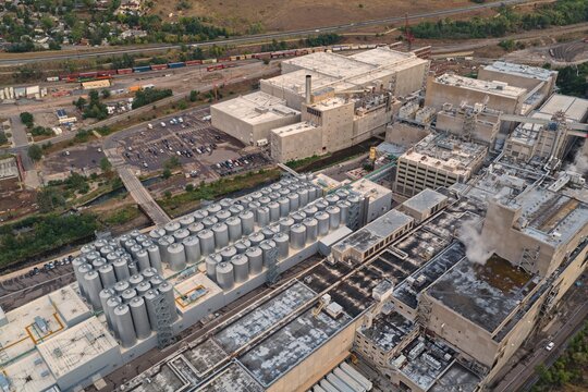 Aerial view of the Coors Brewery complex featuring rows of silver fermentation tanks and industrial buildings in Golden, Colorado, United States.