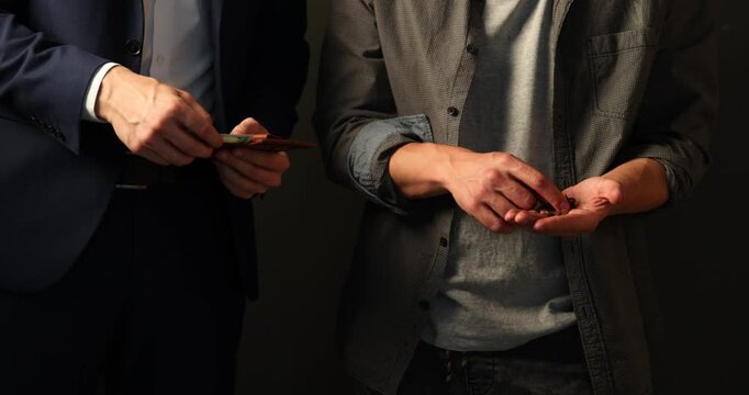 Wealth and poverty. Poor man counting coins and businessman with dollars on dark background, closeup