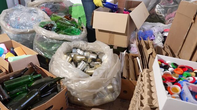 Recycling volunteer sorting recyclable waste at recycling center