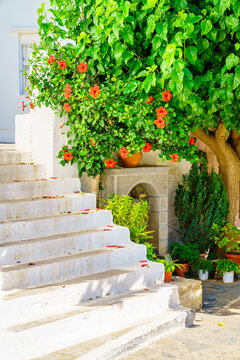 Traditional Cretan courtyard with white stairs and flowers Crete Greece