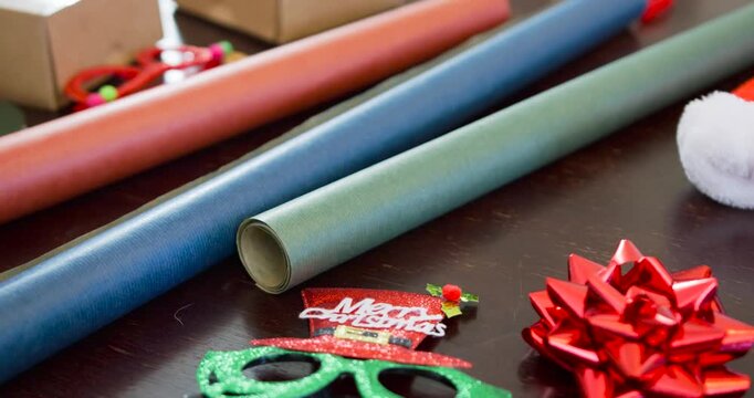 Starting near green specs, camera is pulling back, revealing three rolls for Christmas