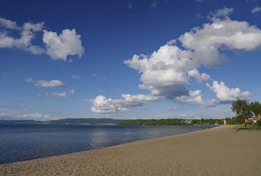 Long sandy beach with white clouds and clear blue sky, Lake V&auml;ttern, J&ouml;nk&ouml;pings l&auml;n, J&ouml;nk&ouml;ping, Sweden