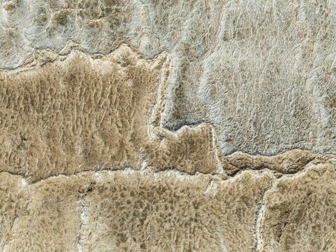 Abstract patterns of saline deposits at the salt works of Walvis Bay. Aerial view. Drone shot. Namibia