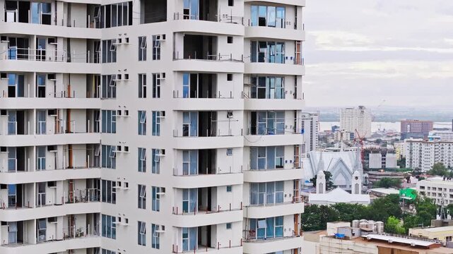 Drone orbits condo tower as white church emerges across Cebu City skylin