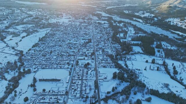 Drone Flight above Melipeuco Grid Town Layout Snow Morning Sunrise high frame rate Chile Landscape