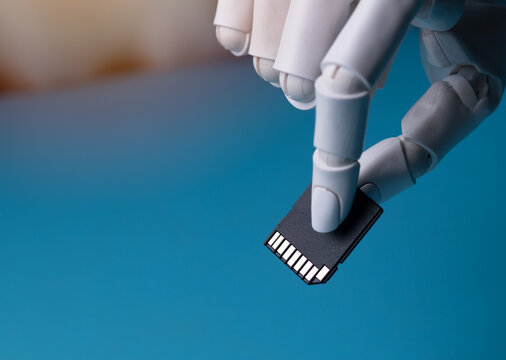 Robotic Hand Holding SD Memory Card Concept of AI Data Storage Close Up