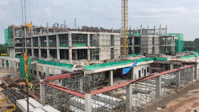 A large multi-storey high-rise building is under construction. The massive structure showcases active urban development and modern engineering.