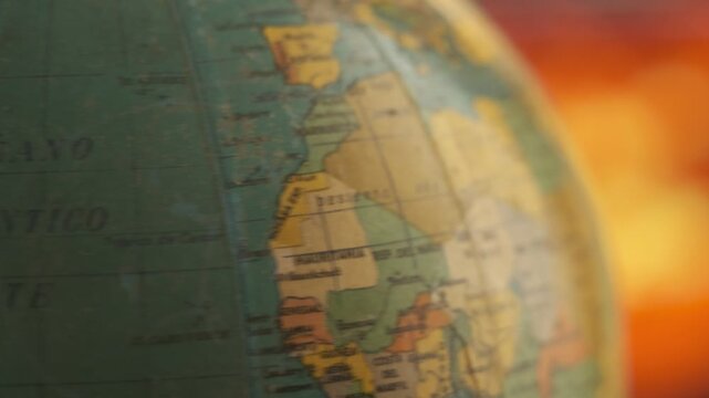 Macro shot of a rotating globe map focused on the Atlantic coastline of South America.