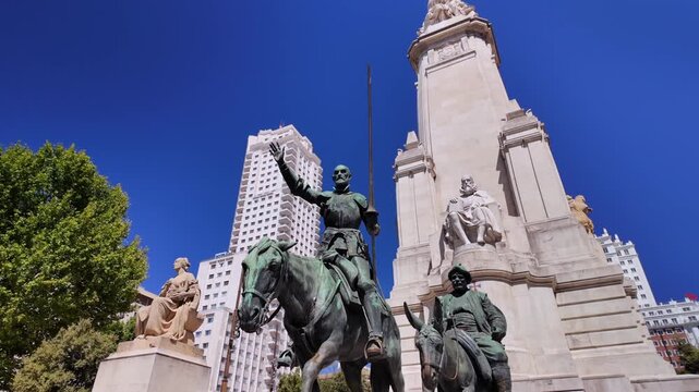 Low angle view of the Don Quixote and Sancho Panza statues at the Cervantes Monument in Plaza de Espana, Madrid.