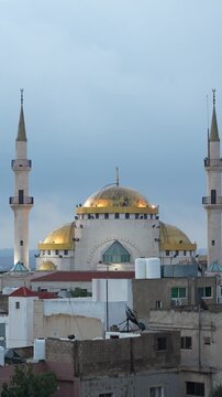 King Hussain Mosque with golden domes in Madaba Jordan, vertical time lapse view