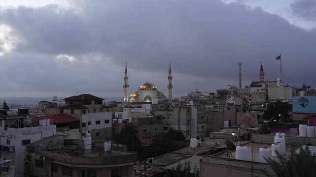 Sunrise timelapse of clouds flying in sky over King Hussein Mosque in Madaba