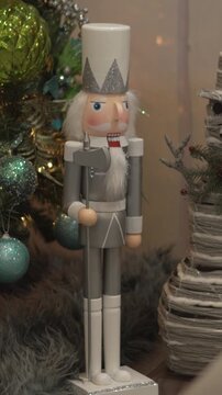 Close-up of decorative nutcracker and snowman figures decorating Christmas tree in living room at home.